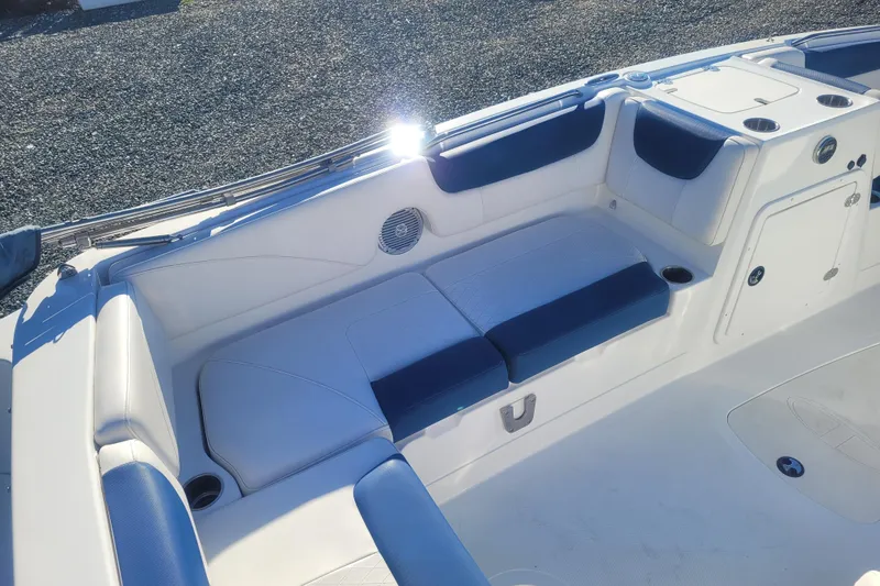 Slide: The Image of 2017 Tahoe 2150 boat interior with blue and white seating, cup holders, and storage compartments. - 9