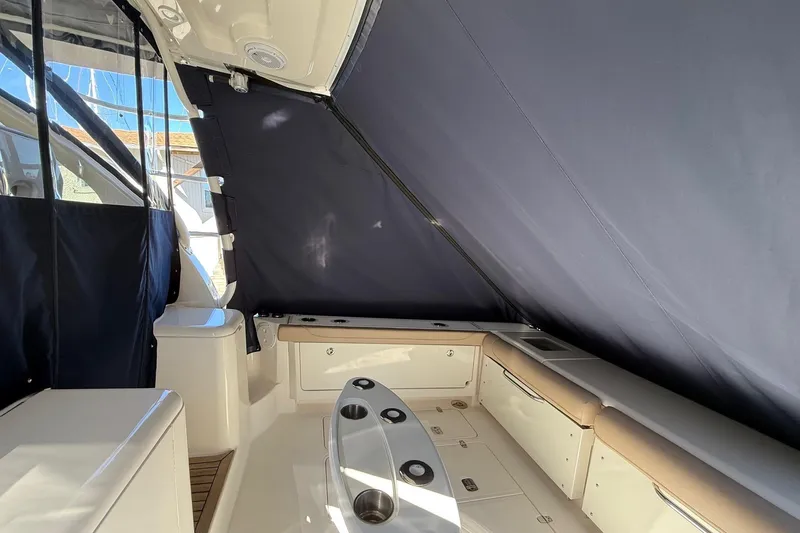 Slide: The Image of 2015 Pursuit OS 385 Offshore boat interior with seating and storage. - 11