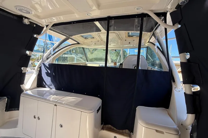 Slide: The Image of 2015 Pursuit OS 385 Offshore boat interior with seating and covered windows. - 6