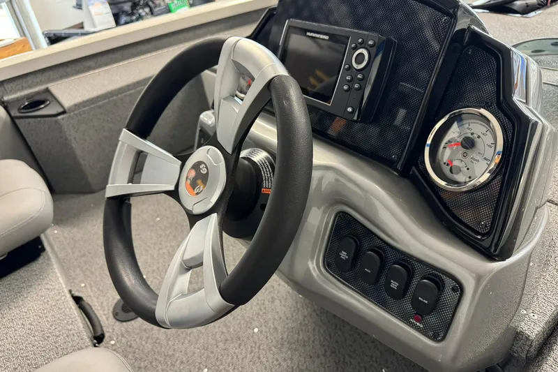 Slide: The Image of 2025 G3 Sportsman 1610 boat dashboard with steering wheel, gauges, and control panel. - 2