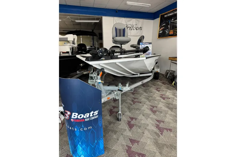 Slide: The Image of 2025 G3 Sportsman 1610 boat displayed indoors on a trailer. - 8
