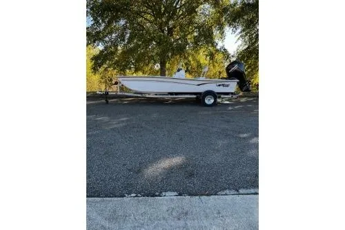 Slide: The Image of 2026 Mako Pro Skiff 17 CC boat on trailer, parked outdoors. - 1