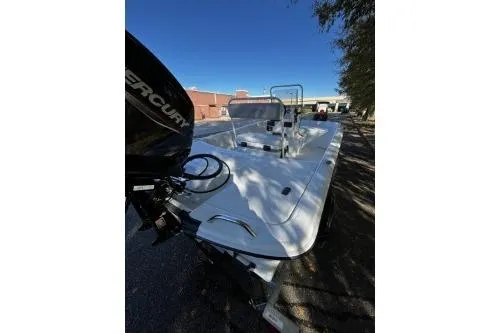 Slide: The Image of 2026 Mako Pro Skiff 17 CC boat with outboard motor, parked outdoors. - 4