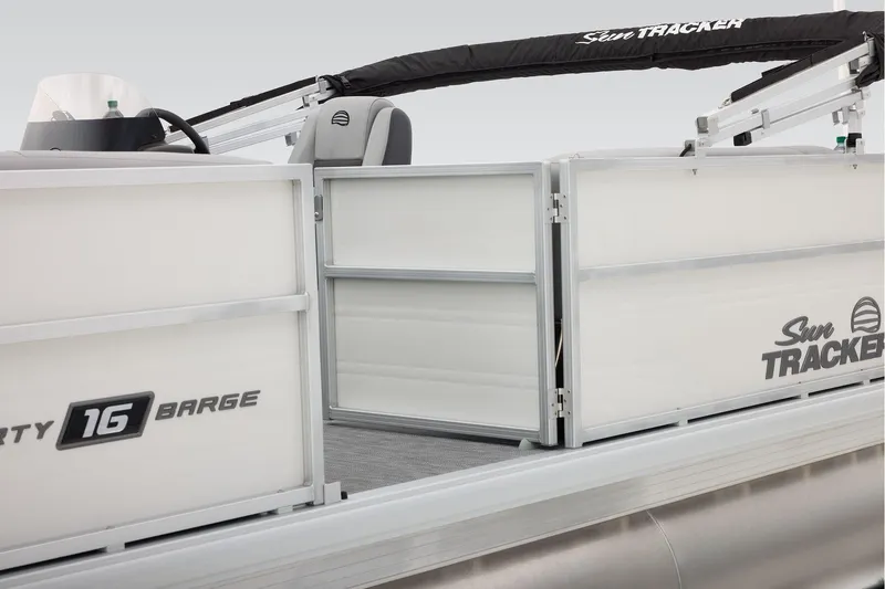 Slide: The Image of 2026 Sun Tracker Party Barge 16 DLX pontoon boat with Mercury engine in parking lot. - 11