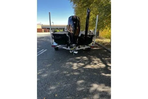 Slide: The Image of 2026 Mako 18 Pro Skiff Backwater Edition boat on trailer, parked outdoors. - 3