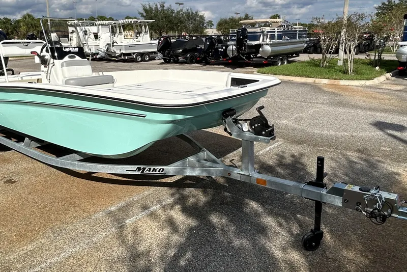 Slide: The Image of 2026 Mako Pro Skiff 17 CC boat on trailer in parking lot. - 2