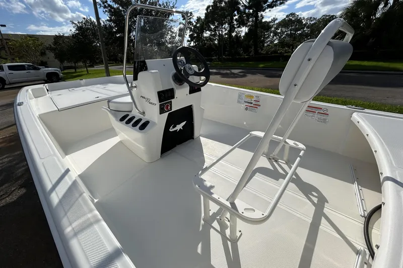 Slide: The Image of 2026 Mako Pro Skiff 17 CC boat interior with steering console and seating. - 4