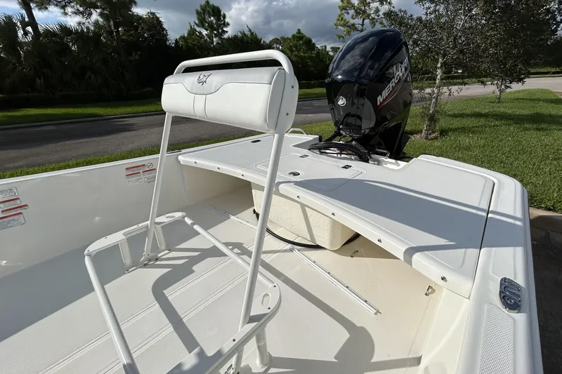 Slide: The Image of 2026 Mako Pro Skiff 17 CC boat with Mercury engine, white seating, and spacious deck. - 8