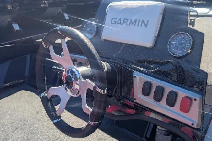 Slide: The Image of Nitro Z18 Pro 2026 boat with Garmin equipment, parked outdoors near blue building. - 6