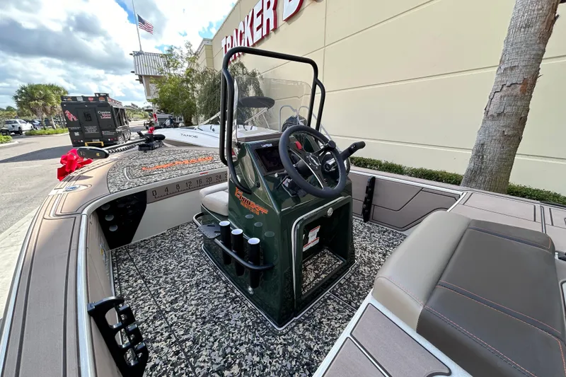 Slide: The Image of 2026 Mako 18 Pro Skiff Backwater Edition boat with steering console, parked outdoors. - 7