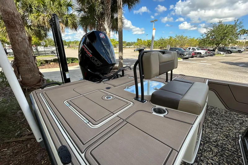 Slide: The Image of 2026 Mako 18 Pro Skiff Backwater Edition boat with seating and motor, parked outdoors. - 8