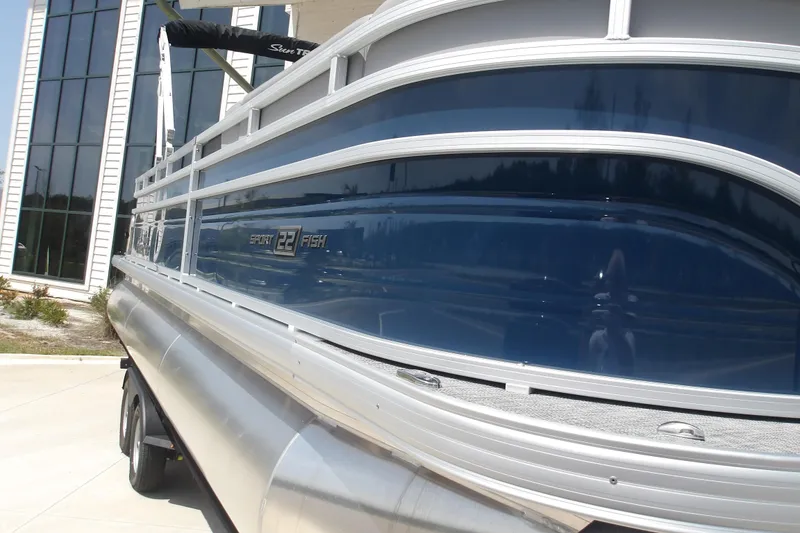 Slide: The Image of 2026 Sun Tracker SportFish 22 XP3 pontoon boat, sleek design, parked outdoors. - 35