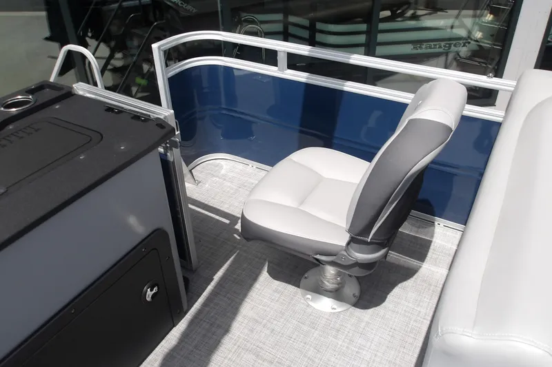 Slide: The Image of 2026 Sun Tracker SportFish 22 XP3 boat interior with swivel seat and railing. - 45