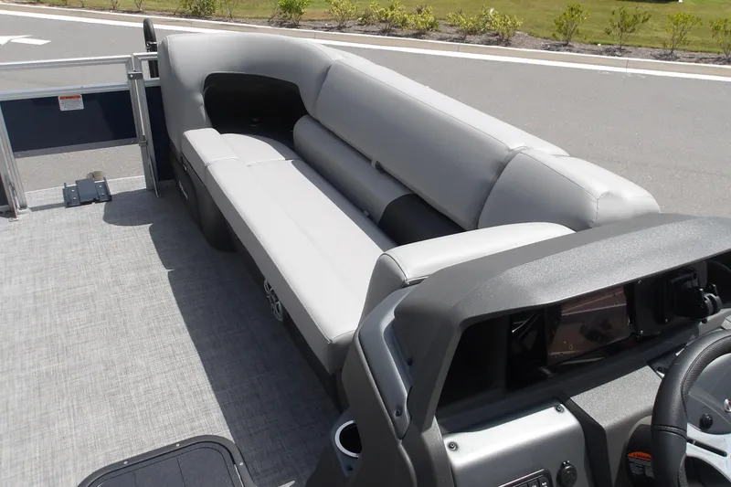 Slide: The Image of 2026 Sun Tracker SportFish 22 XP3 boat interior with gray seating and helm. - 50