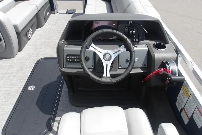 Slide: The Image of 2026 Sun Tracker SportFish 22 XP3 boat dashboard with steering wheel and controls. - 48