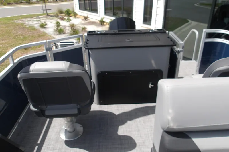 Slide: The Image of 2026 Sun Tracker SportFish 22 XP3 boat interior with seating and storage area. - 55