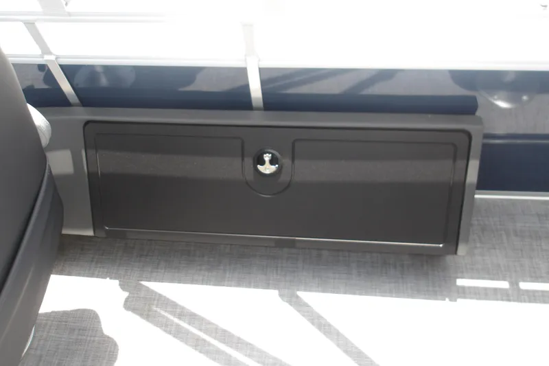 Slide: The Image of 2026 Sun Tracker SportFish 22 XP3 storage compartment with sleek black finish. - 43