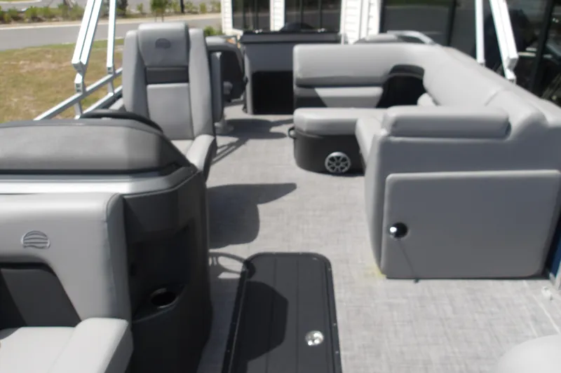 Slide: The Image of 2026 Sun Tracker SportFish 22 XP3 pontoon boat interior with gray seating and spacious layout. - 51
