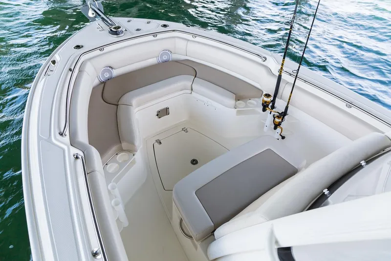 Slide: The Image of Manufacturer Provided Image: 2025 Boston Whaler 230 Outrage boat interior with seating and fishing rods. - 7