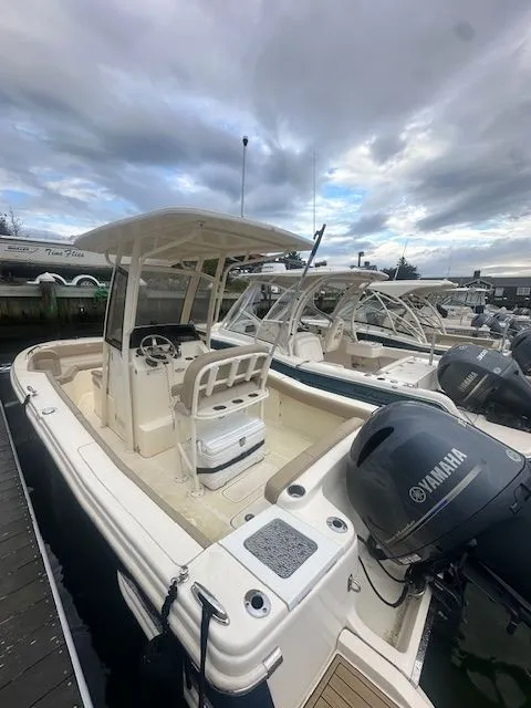 Slide: The Image of 2023 Scout 215 XSF boat docked, featuring Yamaha outboard motor, under cloudy sky. - 3
