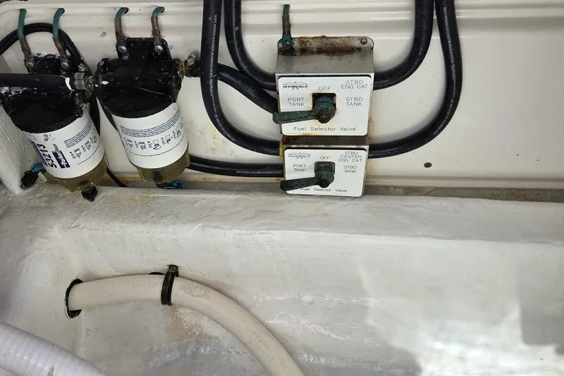 Slide: The Image of Fuel selector valves and filters in a 2020 Invincible 35 Catamaran engine compartment. - 17