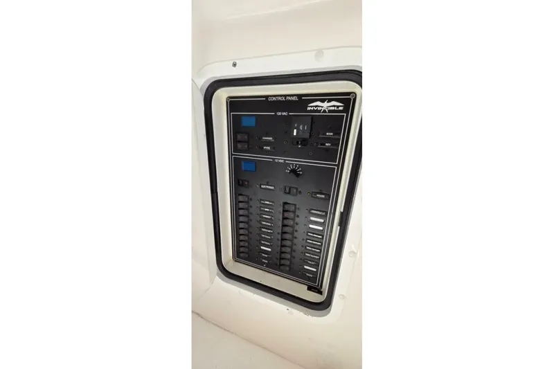 Slide: The Image of Control panel of 2020 Invincible 35 Catamaran, featuring switches and indicators. - 26