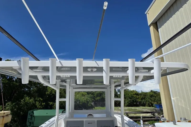 Slide: The Image of 2020 Invincible 35 Catamaran with rod holders and Garmin equipment under a clear blue sky. - 32