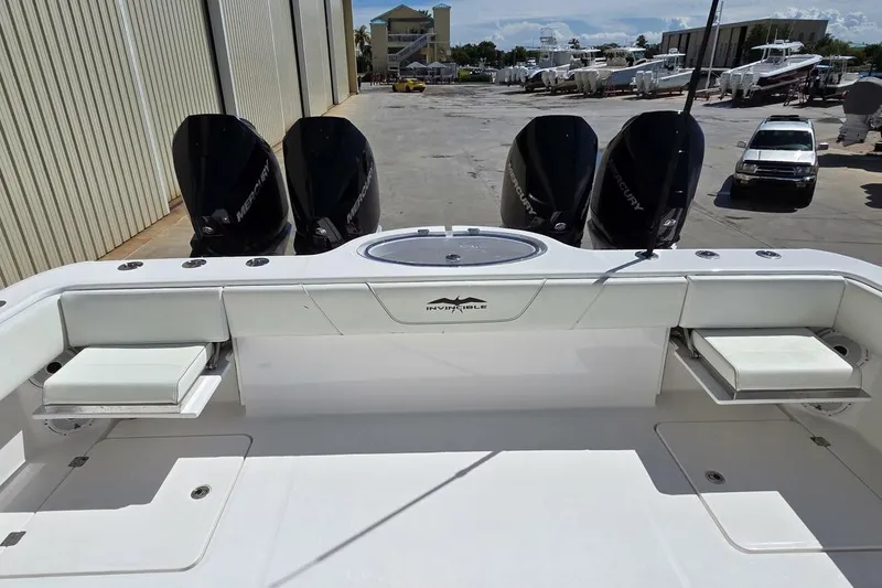 Slide: The Image of 2020 Invincible 35 Catamaran with four Mercury outboard engines, docked in a marina. - 33