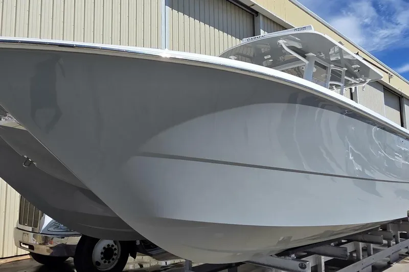 Slide: The Image of 2020 Invincible 35 Catamaran boat on trailer, side view near warehouse. - 45