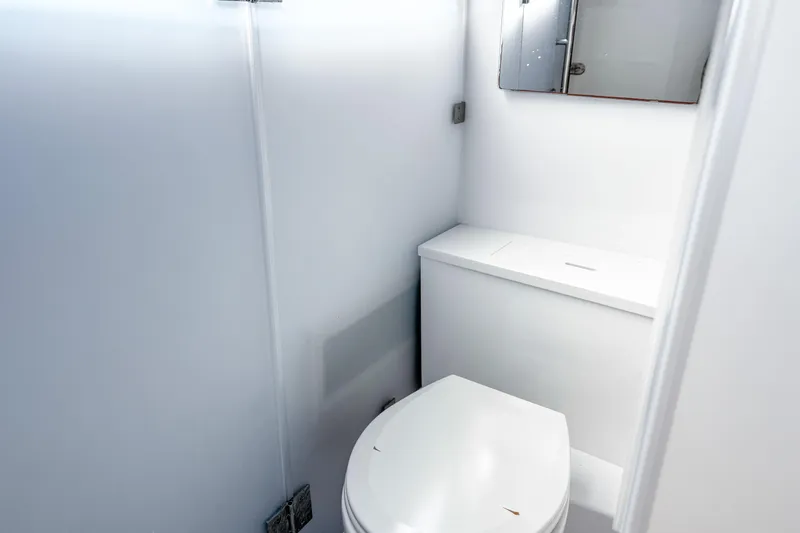 Slide: The Image of 2024 Axopar 37XC CROSS CABIN bathroom with modern white fixtures. - 16