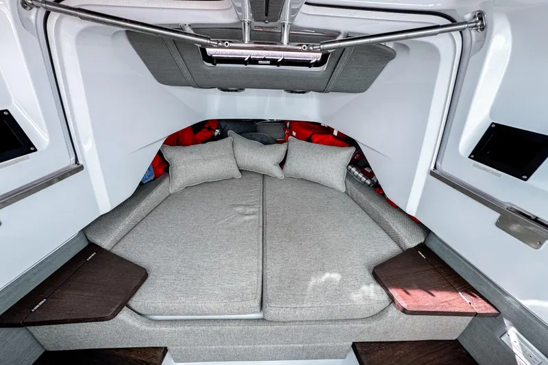 Slide: The Image of 2024 Axopar 37XC CROSS CABIN interior with cozy gray bedding and modern design. - 17