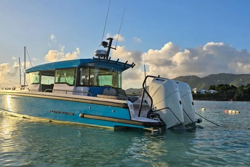 Slide: The Image of 2024 Axopar 37XC CROSS CABIN boat on tranquil water at sunset. - 5
