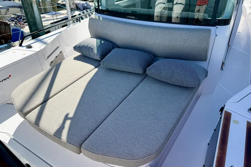 Slide: The Image of 2024 Axopar 37XC CROSS CABIN with comfortable gray sunbed and cushions on deck. - 8