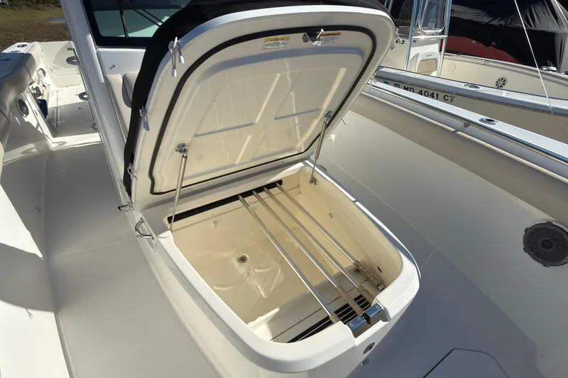 Slide: The Image of 2016 Boston Whaler 330 Outrage boat with open storage compartment on deck. - 15