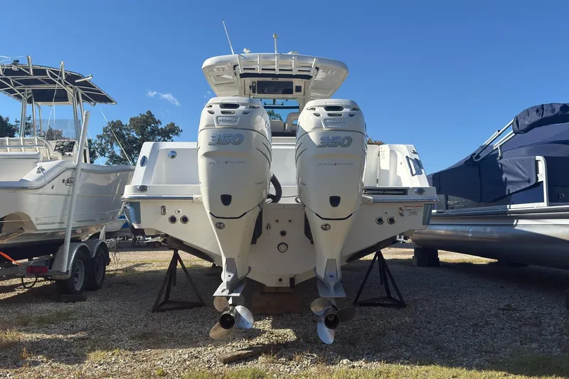 Slide: The Image of 2016 Boston Whaler 330 Outrage with twin 350 engines, docked on land. - 3