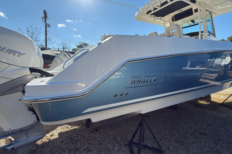 Slide: The Image of 2016 Boston Whaler 330 Outrage boat with blue hull and dual Mercury engines. - 4
