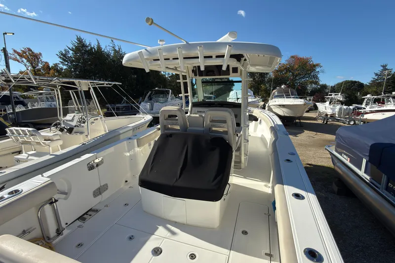 Slide: The Image of 2016 Boston Whaler 330 Outrage boat with center console and seating, docked outdoors. - 5