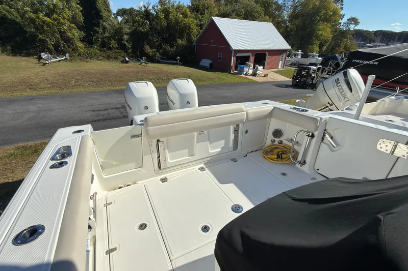 Slide: The Image of 2016 Boston Whaler 330 Outrage boat deck with dual engines and storage compartments. - 6