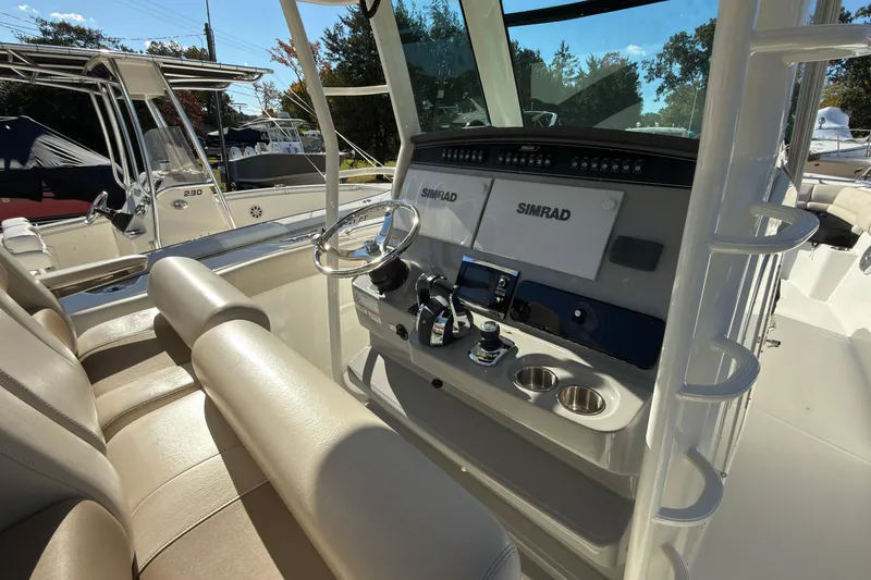 Slide: The Image of 2016 Boston Whaler 330 Outrage boat interior with Simrad navigation system and seating. - 7