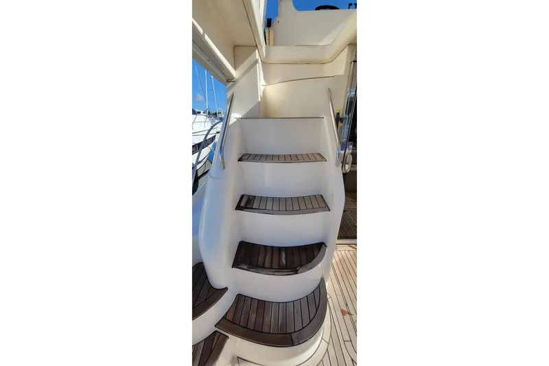 Slide: The Image of 1998 Viking Princess 50 Sport Cruiser at marina, featuring deck and stainless steel railings. - 14