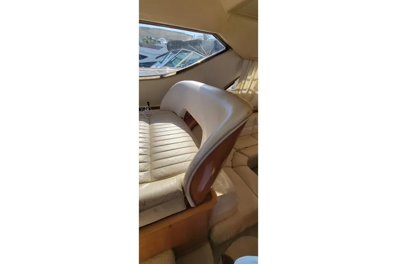 Slide: The Image of Luxurious interior of 1998 Viking Princess 50 Sport Cruiser with elegant seating and wooden accents. - 18