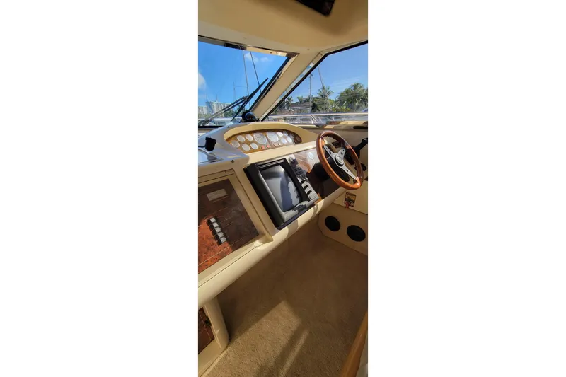 Slide: The Image of Luxurious interior of 1998 Viking Princess 50 Sport Cruiser with plush seating and elegant wood finishes. - 2