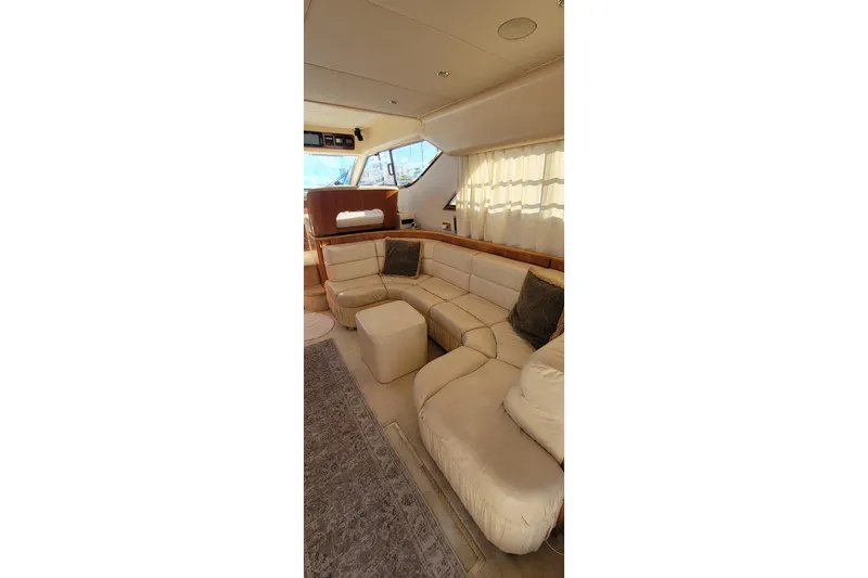Slide: The Image of 1998 Viking Princess 50 Sport Cruiser interior with kitchenette and cozy dining area. - 25
