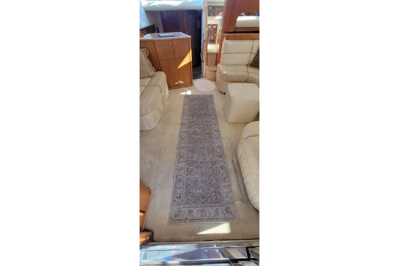 Slide: The Image of 1998 Viking Princess 50 Sport Cruiser interior with cozy seating and wooden accents. - 26