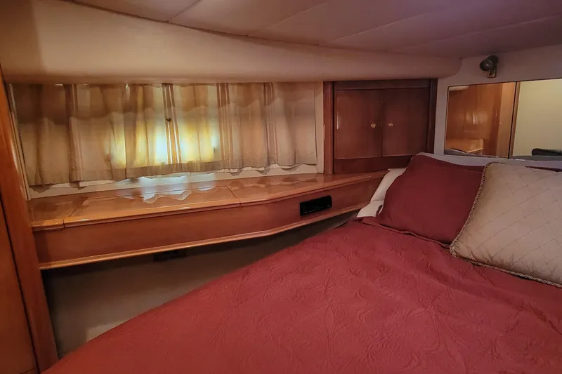 Slide: The Image of Luxurious cabin interior of 1998 Viking Princess 50 Sport Cruiser with red bedding. - 36