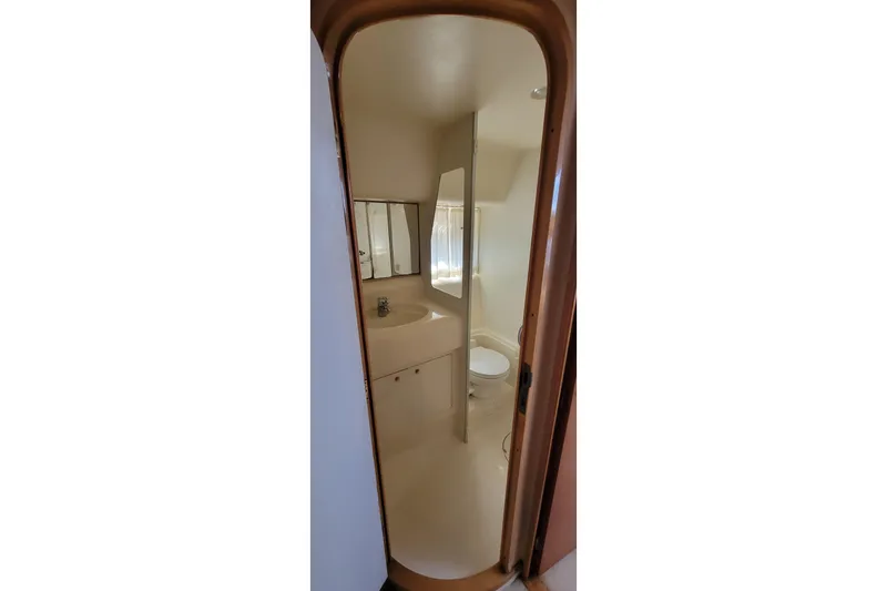 Slide: The Image of Bathroom interior of 1998 Viking Princess 50 Sport Cruiser with shower and sink. - 39