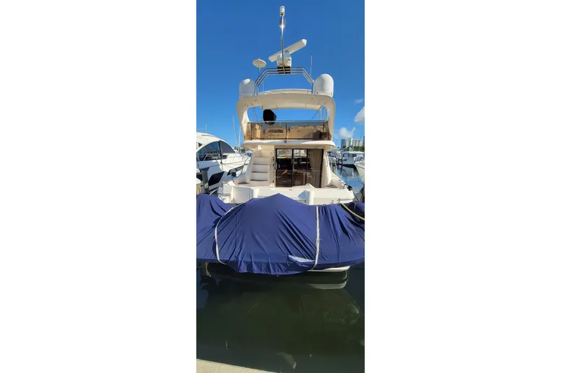 Slide: The Image of 1998 Viking Princess 50 Sport Cruiser helm with wood steering wheel and navigation controls. - 4