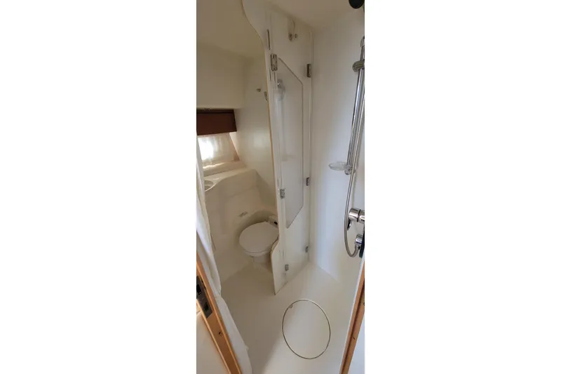 Slide: The Image of Open storage compartment with mirror on a 1998 Viking Princess 50 Sport Cruiser. - 41