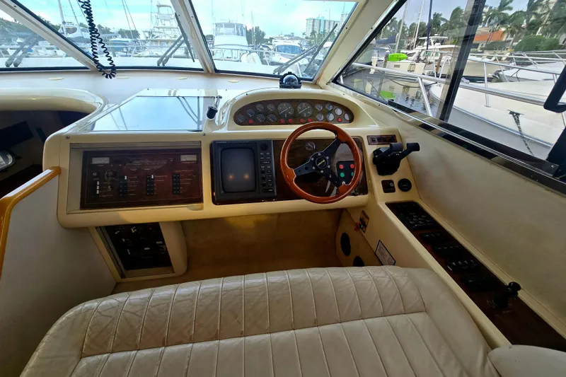 Slide: The Image of 1998 Viking Princess 50 Sport Cruiser helm with steering wheel and control panel. - 46
