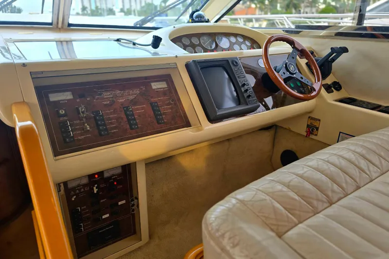 Slide: The Image of 1998 Viking Princess 50 Sport Cruiser helm with control panel and steering wheel. - 48